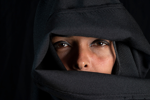 Portrait of a woman wearing hijab against black background. Salvador, Bahia, Brazil.