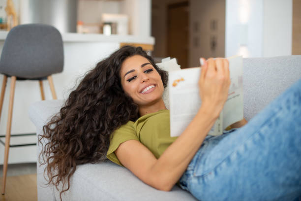 istock Woman relaxing and reading a book 1409580124