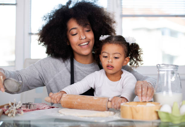 istock Mother and daughter are baking together 1409585405
