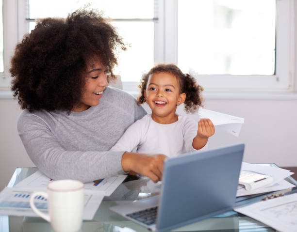 istock Young mother working and spending time with her daughter 1409585415