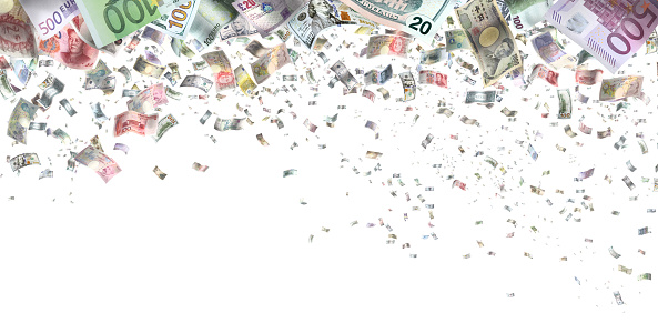 Large group of various paper currencies falling from sky