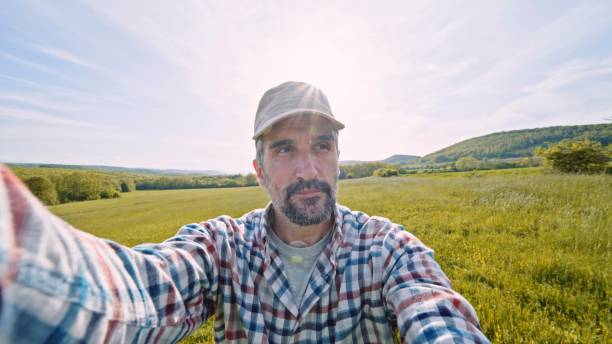 istock Farmer vlogging in wheat crops at sunset in spring. 1409590261