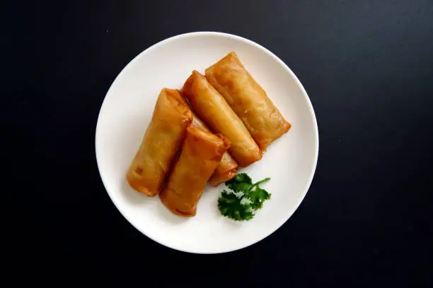 Multiple fried spring rolls on the table