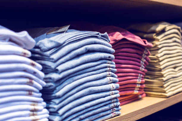 istock Selective focus to many clothes folded in the shop. Many stack of clothes. 1409594209