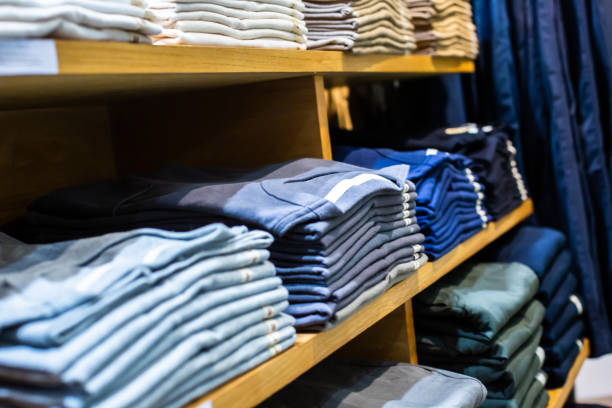istock Selective focus to many clothes folded in the shop. Many stack of clothes. 1409594326