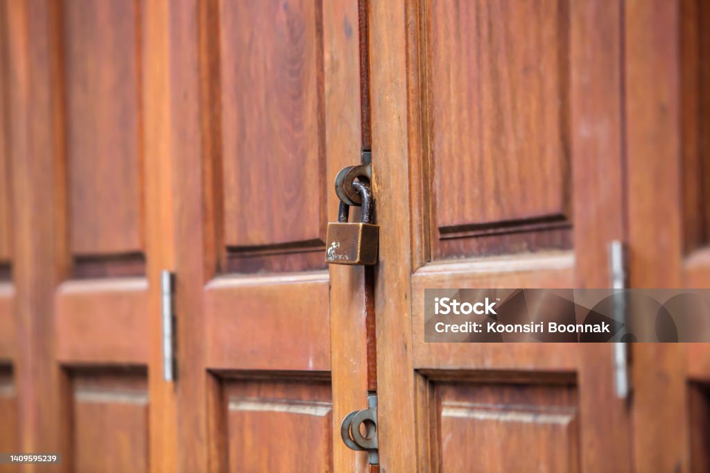 lock on the door of an old farmhouse, Locked wooden door. lock on the door of an old farmhouse, Locked wooden door ,locked vintage brown door. Antique Stock Photo