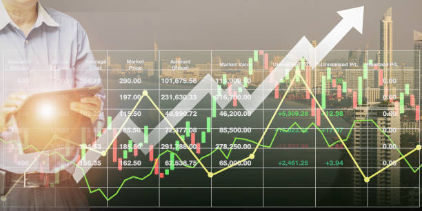 Stock index financial data with graph, chart, candlesticks; and arrow up  show successful investment with businessman control tablet on modern buildings for travel industry and business background. stock photo