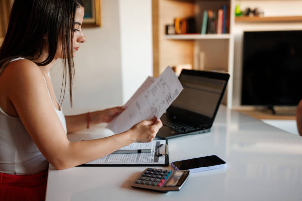 istock Woman paying bills from home 1409603090