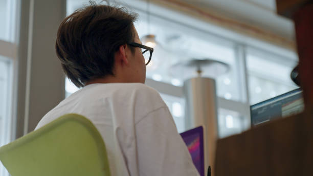 istock Young man editing video at the office. 1409603732