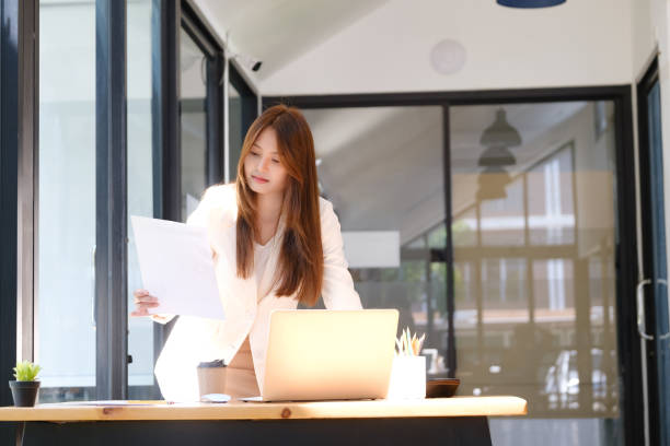 Businesswoman is working at office and using laptop. stock photo