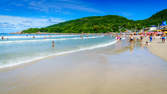 Florianopolis, Brazil, January 11, 2022: crowded beach Praia da Barra da Lagoa in Florianopolis, Brazil