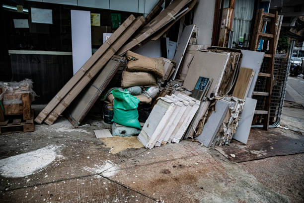 High angle close-up view of rubble and a wooden door inside garbage container in the street in the city of Valencia, Spain