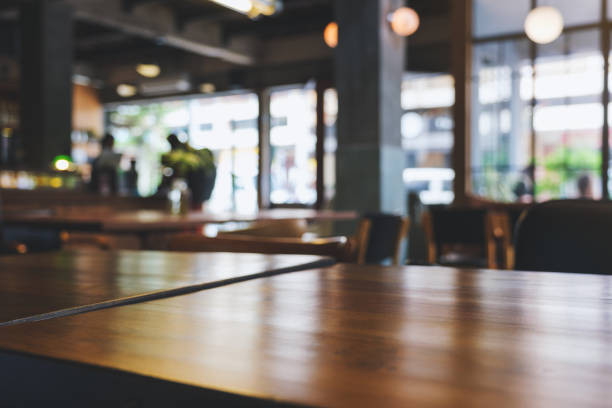 Wooden table top with blurred background in cafe