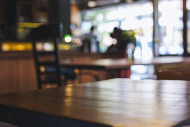 istock Wooden table top with blurred background in cafe 1409606976