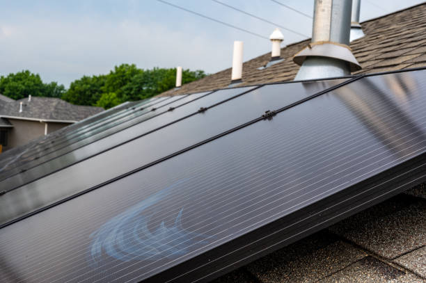 istock Selective focus on solar panels installed on a residential asphalt shingle roof 1409609221