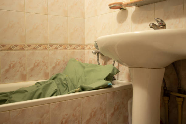 istock Sleeping in the bathroom inside the bathroom with a pillow and a blanket in Ukraine during rocket attacks over cities, the war in Ukraine, a protective place for people in the apartment 1409611140