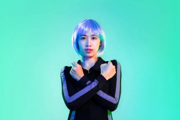 Young asian woman blue and silver hair color in black dress cyberspace and super hero concept posing on the green screen background.