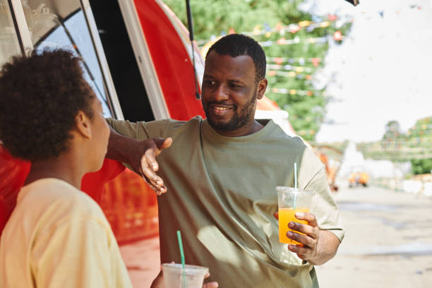 istock Father talking to son during leisure time in park 1409614632