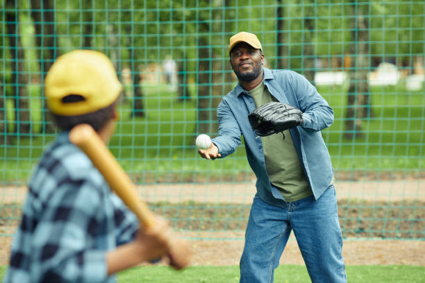 father playing baseball together with his son - baseball baseballs catching baseball glove imagens e fotografias de stock