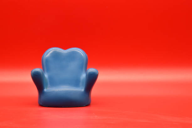 Rubber blue armchair isolated on red background