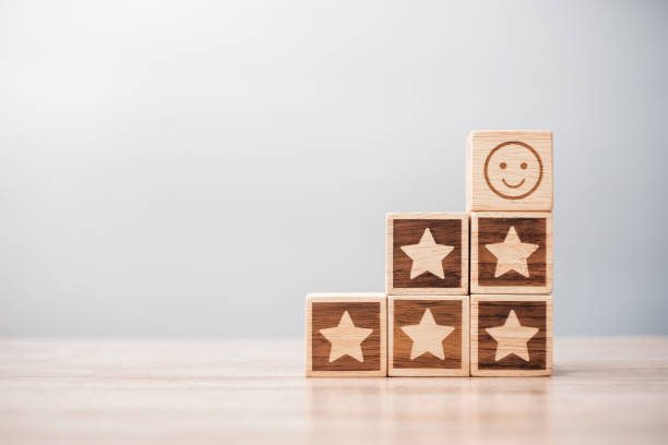 istock emotion face and Star symbol blocks on table background. Service rating, ranking, customer review, satisfaction, evaluation and feedback concept 1409620559