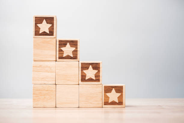 istock star symbol block on table background. Service rating, ranking, customer review, satisfaction, evaluation and feedback concept 1409620929
