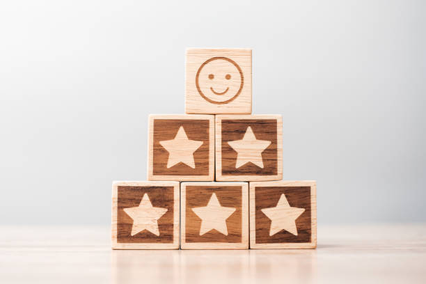 istock emotion face and Star symbol blocks on table background. Service rating, ranking, customer review, satisfaction, evaluation and feedback concept 1409621121