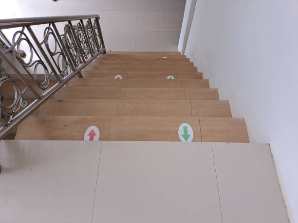 household stairs with directions for green and red arrows so that stair users can be orderly stock photo