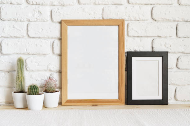istock Square wooden photo frame and cactus plants on the table 1409624044