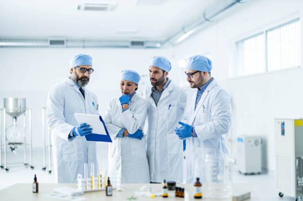 istock Team of scientists examining research data in laboratory. 1409624827