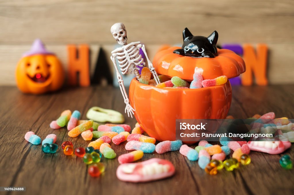 Happy Halloween day with ghost candies, pumpkin bowl, Jack O lantern and decorative (selective focus). Trick or Threat, Hello October, fall autumn, Festive, party and holiday concept Halloween Stock Photo