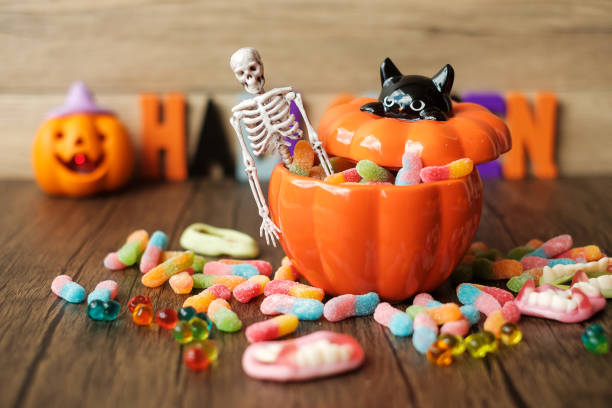 happy halloween day with ghost candies, pumpkin bowl, jack o lantern and decorative (selective focus). trick or threat, hello october, fall autumn, festive, party and holiday concept - halloween imagens e fotografias de stock