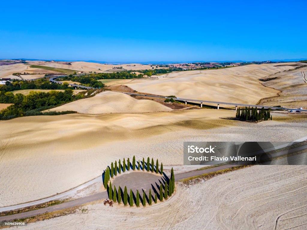 Cypress trees of San Quirico d'Orcia - Tuscany Cypress trees of San Quirico d'Orcia immersed in a solitary landscape Italian Culture Stock Photo