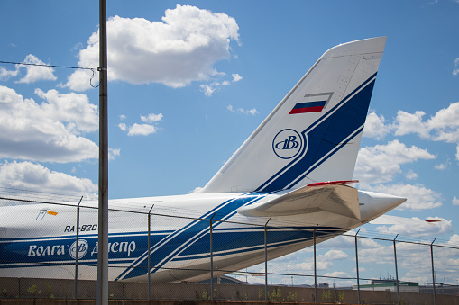 A Russian-registered, Antonov 124 cargo plane, owned by Volga-Dnepr, is grounded, seen behind the fence at Pearson Airport during the Russian invasion of Ukraine.