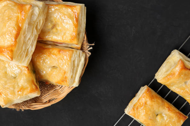 istock Delicious fresh square butter pie bread in basket on a black background. Top view 1409630739