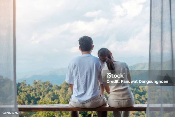 Couple Tourist Relaxing And Looking Mountain View At Countryside Home Or Homestay In The Morning Vacation Together Travel Honeymoon Blogger Journey Trip And Relaxing Concept Stock Photo - Download Image Now