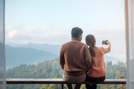 couple tourist taking Photo by mobile smartphone, Blogger looking mountain view. together Travel, vacation, journey, trip and relaxing concept
