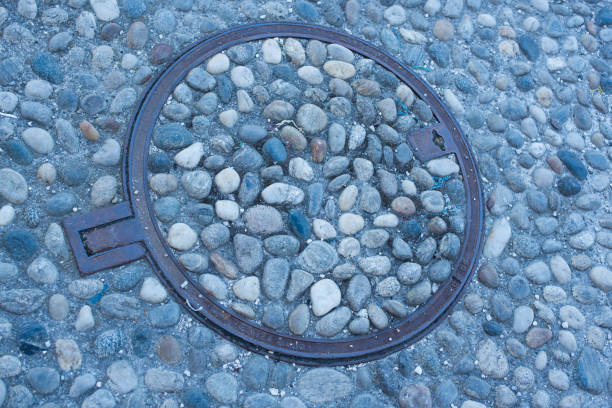 iron manhole cover with a detail from the coat of arms of the city of Lisbon; Lisbon, Portugal