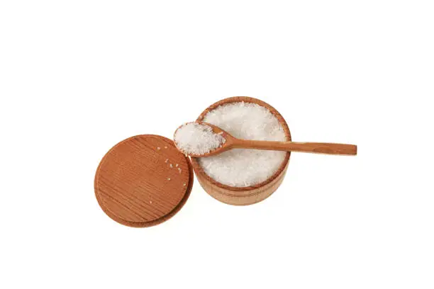 Glutamic acid monosodium salt in wooden bowl with spoon on white background. Msg. Food additive E621. Flavor seasoning for enhancing food impressions.