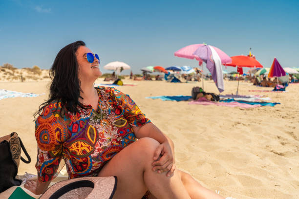 Women sunbathing at Praia do Barril in Tavira, Portugal Women, Sunbathing, Praia do Barril, Tavira, Portugal algarve holiday stock pictures, royalty-free photos & images