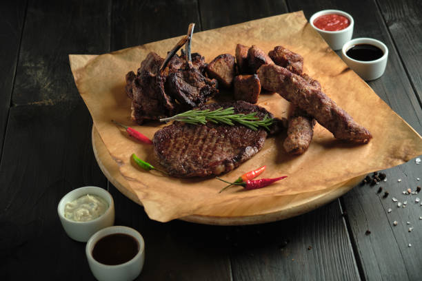 istock Meat on the bone on a wooden board catering menu 1409641609