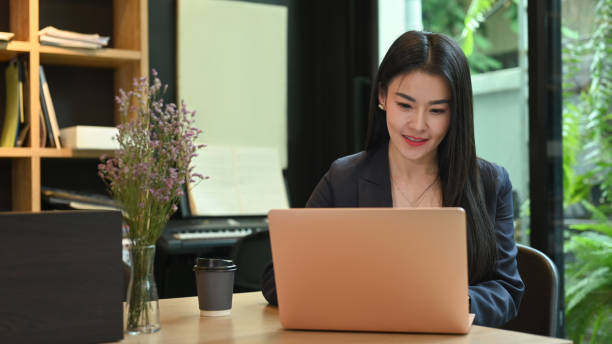 istock Asian woman entrepreneur working, analyzing online information on laptop computer. 1409642462