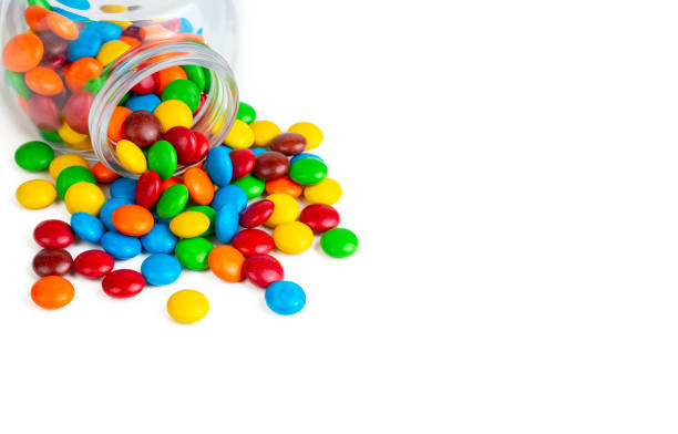 istock Colorful chocolate buttons on a white background 1409642841