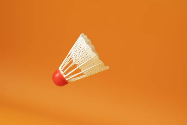 istock badminton shuttlecock flies on orange background 1409643308