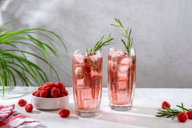 istock Summer refreshing non-alcoholic cocktails. Raspberry lemonade garnished with fresh rosemary. Summer raspberry beverage with sparkling water. Copy space. 1409645323