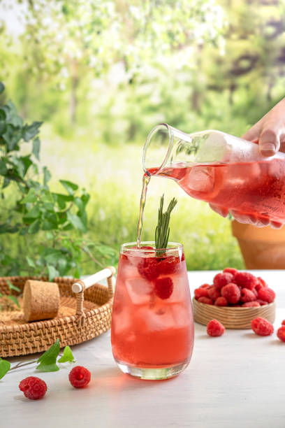 istock Summer refreshing non-alcoholic cocktails. Raspberry lemonade garnished with fresh rosemary. Summer raspberry beverage with sparkling water. Copy space. 1409645872