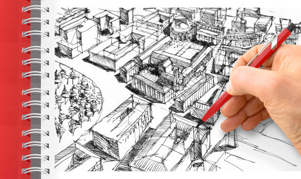 istock Planning a new city - Engineer-architect drawing with a pencil a sketch of a new modern imaginary town - concept image 1409647345