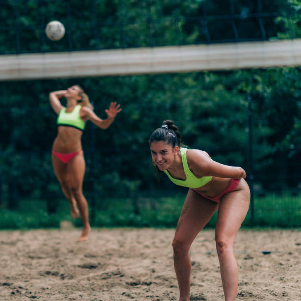 istock Beach Volleyball, Female Player Serving The Ball 1409648672