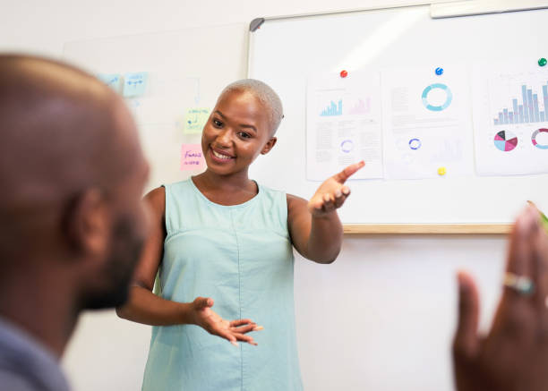 istock A Black woman answers a question during a presentation in the workplace 1409648697