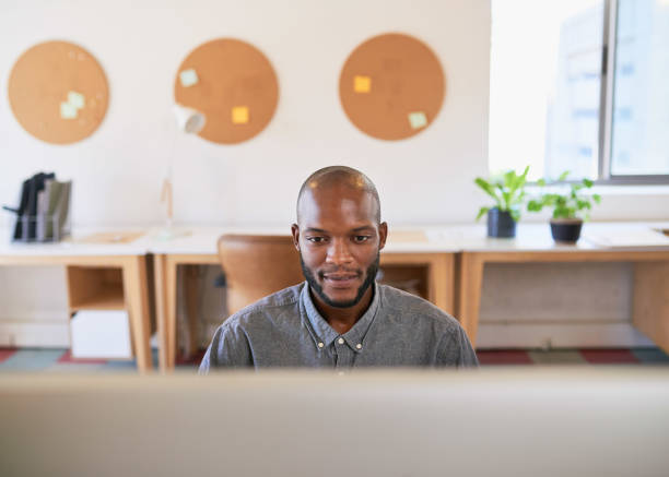istock A Black businessman works at his wide screen computer in the office 1409649080